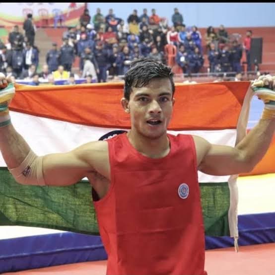 Evolve Fight Club's coach holding the Indian flag after a competition win